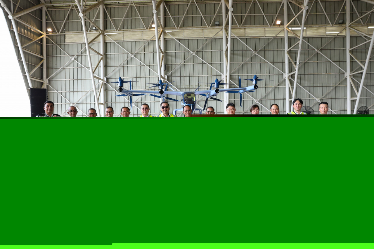 Officials from Hyundai Motor Group, Indonesia’s Ministry of Transportation and Nusantara Capital City Authority pose for a photo in front of a miniature S-A2 aircraft at Samarinda Airport in East Kalimantan, Indonesia on Monday. (Hyundai Motor Group)