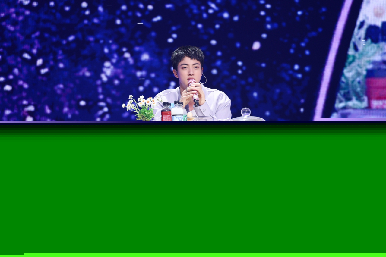 Jin speaks during a 'mukbang' session at his fan-meeting event held at Jamsil Arena, Seoul, June 13. (Big Hit Music)